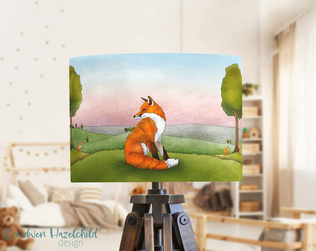A table lampshade with an illustration of a fox in it, in a bright and naturally lit playroom