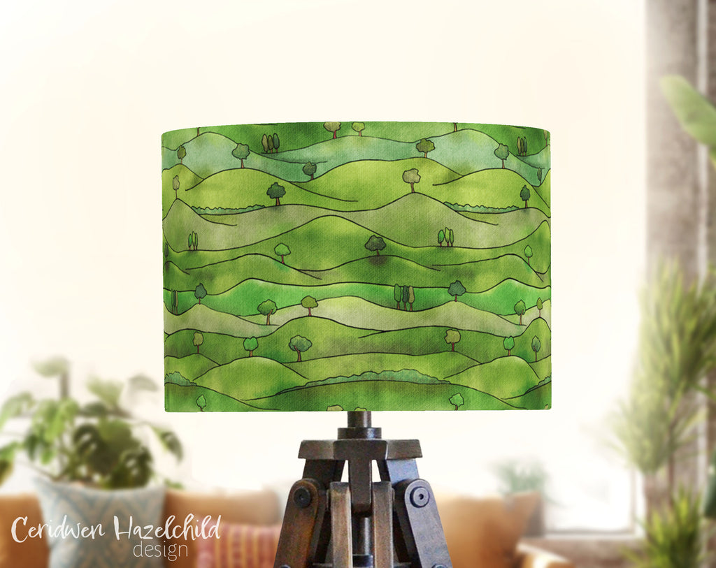 A lampshade featuring a pattern of rolling country hills.