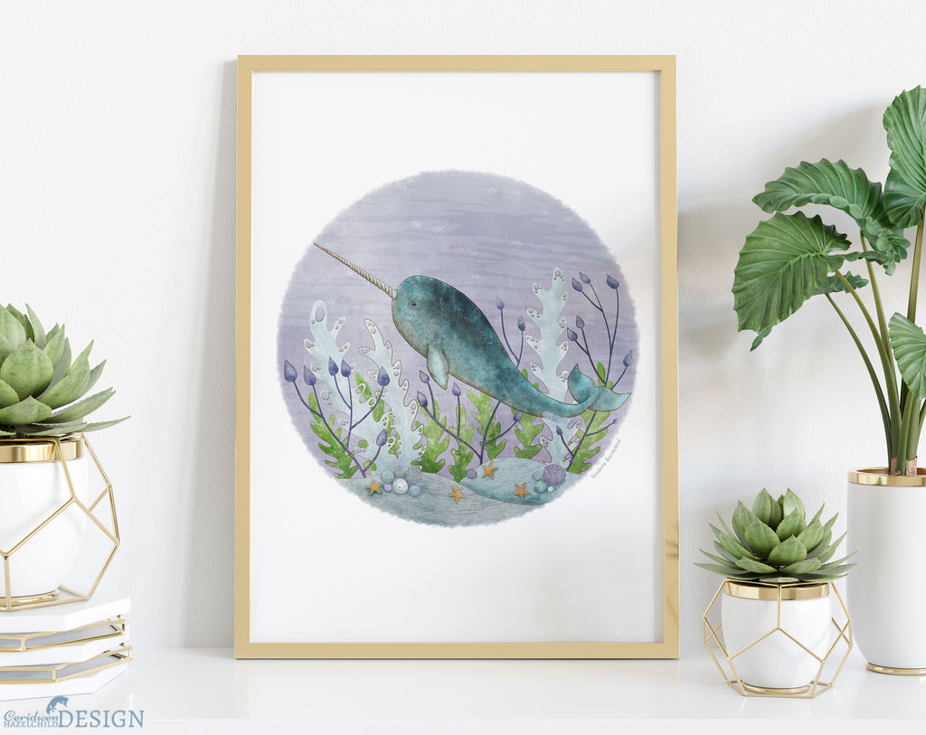 A framed print of an illustration of a narwhal swimming through seaweed by Ceridwen Hazelchild Design.