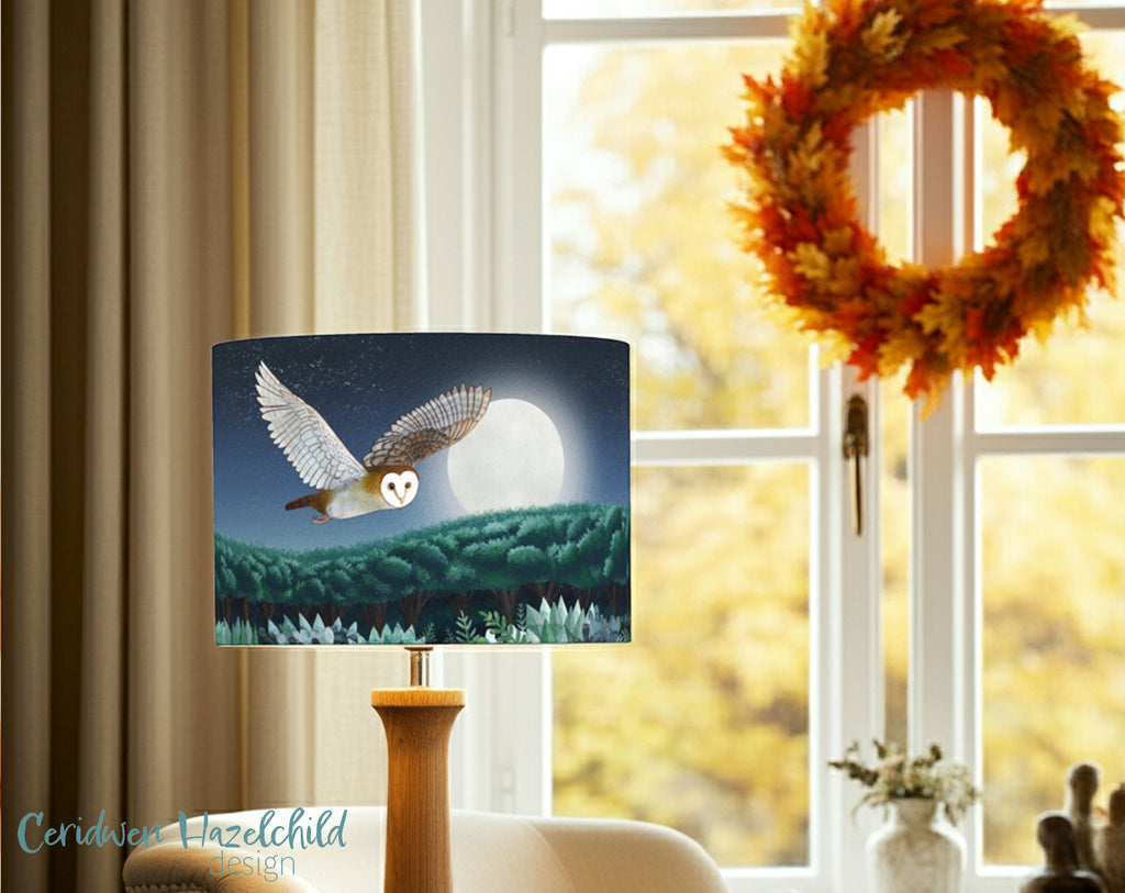 An owl lampshade in an autumnal styled living room with a wreath on a window