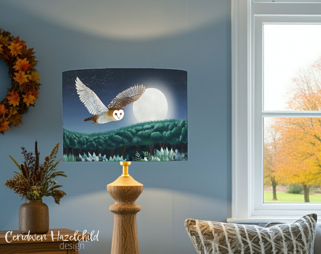 Lamp with owl design on a blue wall with autumn decorations