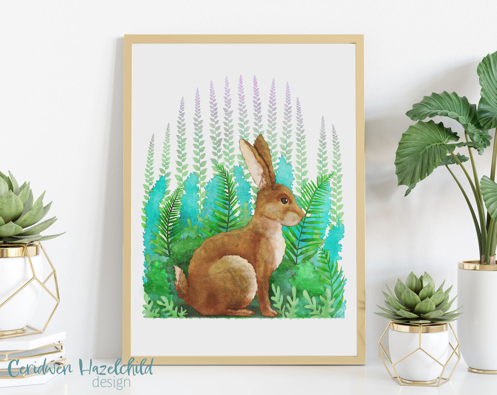 Framed artwork of a rabbit among plants on a white wall with decorative plants.