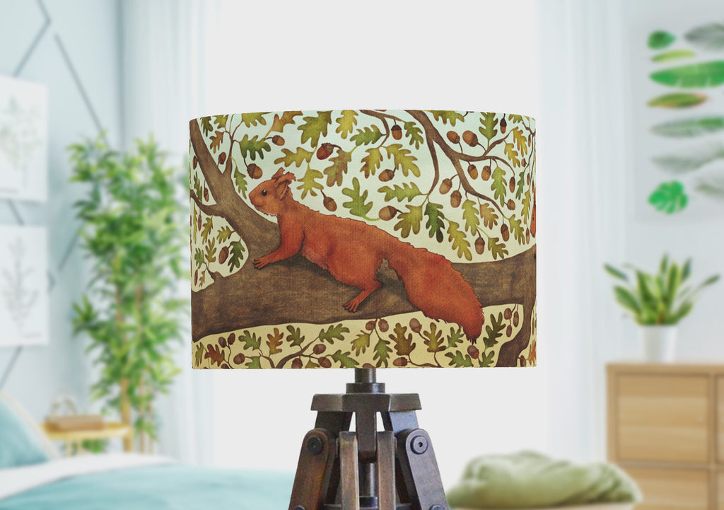 A woodland animal lampshade with a squirrel illustration, rotating to show the wrap around scene.
