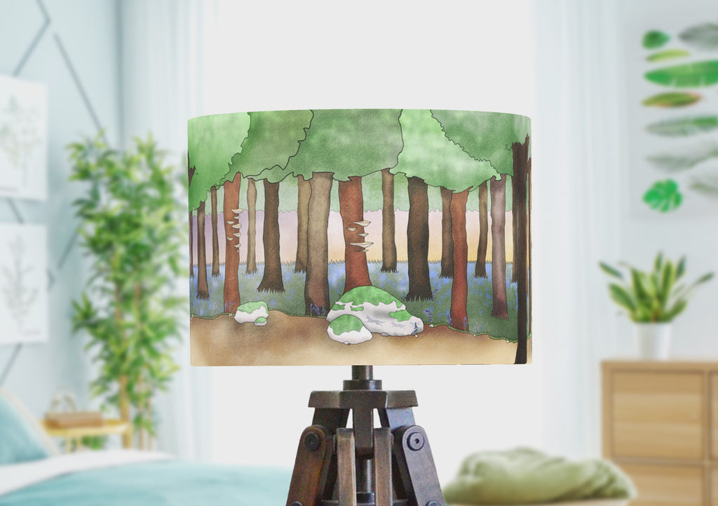 A fairytale lampshade showing Red Riding Hood walking through the woodland with a wolf. The handamde lampshade rotates to show the full panoramic scene illustrated by the artist.