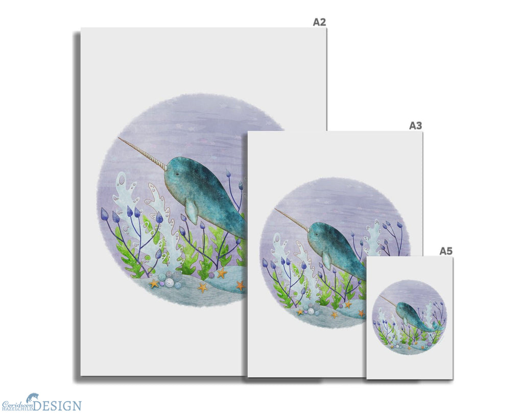 Three sizes of giclee art prints, featuring a print of a narwhal by Ceridwen Hazelchild.